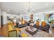 Open concept living room with kitchen island and hardwood floors at 361 Elkins Pl, Peachtree City, GA 30269