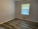 Simple bedroom with vinyl flooring and window at 266 Ridge Trl, Riverdale, GA 30274