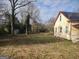 Large backyard with mature trees and a storage building at 41 W Main St, Hampton, GA 30228