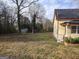 Spacious backyard with mature trees and a storage shed at 41 W Main St, Hampton, GA 30228
