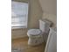 Small bathroom with toilet and window at 41 W Main St, Hampton, GA 30228