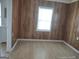 Simple bedroom with wood paneled walls at 41 W Main St, Hampton, GA 30228