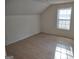 Simple bedroom featuring light walls and laminate floors at 41 W Main St, Hampton, GA 30228