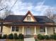House exterior featuring a charming yellow facade, and a spacious front yard at 41 W Main St, Hampton, GA 30228