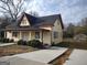 Inviting yellow house with a covered porch and a long driveway at 41 W Main St, Hampton, GA 30228