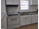 Simple kitchen featuring white cabinets and granite countertops at 41 W Main St, Hampton, GA 30228