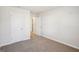 Spacious bedroom showing the carpeted floor with two doors and neutral paint at 1961 Fairchild Ave, Grayson, GA 30017