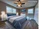 Virtually staged bedroom with king bed and wood-look floors at 1351 John Robert Dr, Morrow, GA 30260