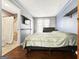 Cozy bedroom with hardwood floors and a TV; ensuite bathroom with a tiled shower at 107 Stratford Ct, Peachtree City, GA 30269