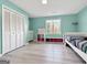 Bright bedroom with a daybed, shelving, and a large window at 107 Stratford Ct, Peachtree City, GA 30269