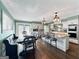 Spacious eat-in kitchen with granite countertops, stainless appliances, a large island, a breakfast bar, and wood floors at 107 Stratford Ct, Peachtree City, GA 30269