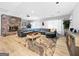 Spacious living room features a stone fireplace, large sectional sofa, and wood floors at 107 Stratford Ct, Peachtree City, GA 30269