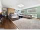 Comfortable living room with a stone fireplace, large sofa, and ample natural light from windows and skylight at 107 Stratford Ct, Peachtree City, GA 30269