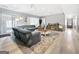 A spacious living room with a large sofa, media center, and plush rug provides a cozy and inviting space for entertaining at 107 Stratford Ct, Peachtree City, GA 30269