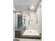 Modern glass-enclosed shower with white subway tile, rain shower head, and granite seat at 107 Stratford Ct, Peachtree City, GA 30269
