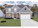 Two-story home with gray siding, brick accents, and a two-car garage at 3110 Azteca Way, Dacula, GA 30019