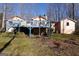 Exterior view of the home featuring a raised deck and a spacious backyard at 125 Oak Leaf Dr, Stockbridge, GA 30281