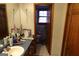 Bathroom featuring a sink with wood cabinets, a mirror, and a view of the toilet at 125 Oak Leaf Dr, Stockbridge, GA 30281