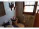 Bathroom with a toilet and shelf, and natural light coming in through the window at 125 Oak Leaf Dr, Stockbridge, GA 30281