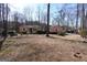 Ranch home with neutral siding, white trim, and a yard with mature shrubs and trees at 125 Oak Leaf Dr, Stockbridge, GA 30281