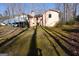 Rear view showing home's deck and landscape with mature trees at 125 Oak Leaf Dr, Stockbridge, GA 30281