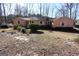 Ranch home with neutral siding, white trim, and a yard with mature shrubs and trees at 125 Oak Leaf Dr, Stockbridge, GA 30281