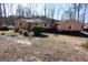 Ranch home with neutral siding, white trim, and a yard with mature shrubs and trees at 125 Oak Leaf Dr, Stockbridge, GA 30281