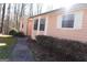 Light pink single story home with white trim around windows and green shrubbery at 125 Oak Leaf Dr, Stockbridge, GA 30281