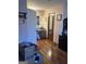 Hallway leading to a bathroom featuring wood floors, pink walls, and white door at 125 Oak Leaf Dr, Stockbridge, GA 30281