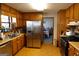 Well-lit kitchen featuring stainless steel refrigerator, wood cabinets, and tiled flooring at 125 Oak Leaf Dr, Stockbridge, GA 30281