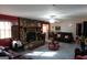 Open living room with a stone fireplace, ceiling fan, and comfortable seating area at 125 Oak Leaf Dr, Stockbridge, GA 30281