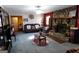 Open living room with ceiling fan, stone fireplace, comfortable seating and unique decor at 125 Oak Leaf Dr, Stockbridge, GA 30281