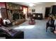 Spacious living room features a stone fireplace, ceiling fan and comfortable seating arrangements at 125 Oak Leaf Dr, Stockbridge, GA 30281