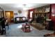 Bright living room with stone fireplace, ceiling fan, carpeted floors and multiple seating options at 125 Oak Leaf Dr, Stockbridge, GA 30281