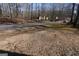 Street view with tall trees along the roadside with a light-colored ranch-style home in the distance at 125 Oak Leaf Dr, Stockbridge, GA 30281