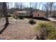 Spacious yard with tall trees bordering a light-colored ranch-style home in the background at 125 Oak Leaf Dr, Stockbridge, GA 30281