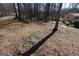 Wide yard with a mix of grass and ground cover leading to a quaint house at 125 Oak Leaf Dr, Stockbridge, GA 30281