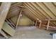 Unfinished attic featuring exposed rafters, offering potential for storage or additional living space at 25 Brookstone Ct, Covington, GA 30016