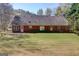 Expansive backyard featuring a brick home exterior and a well-maintained lawn at 25 Brookstone Ct, Covington, GA 30016