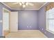 Comfortable bedroom painted light purple with a ceiling fan at 25 Brookstone Ct, Covington, GA 30016
