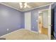 Comfortable bedroom painted light purple with a ceiling fan at 25 Brookstone Ct, Covington, GA 30016