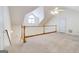 Bright bonus room features carpeted floors, white walls, and wooden railing offering versatile living space at 25 Brookstone Ct, Covington, GA 30016