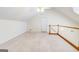 Upstairs Bonus Room with neutral walls, carpet, ceiling fan, and railing overlooking the floor below at 25 Brookstone Ct, Covington, GA 30016