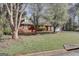 A lush front yard with mature trees surrounding this brick home at 25 Brookstone Ct, Covington, GA 30016