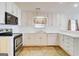 Bright kitchen features white cabinetry and modern stainless steel appliances at 25 Brookstone Ct, Covington, GA 30016