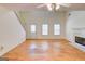 Open living room with hardwood floors, bright windows, and a cozy fireplace offering an inviting space at 25 Brookstone Ct, Covington, GA 30016