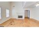 Bright, open-concept living room featuring hardwood floors and a fireplace at 25 Brookstone Ct, Covington, GA 30016