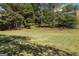 The expansive backyard is filled with mature trees, offering plenty of shade and privacy at 9770 Coleman Rd, Roswell, GA 30075