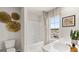 Bright bathroom featuring double sinks, a bathtub-shower combination, and modern fixtures at 313 Sound Cir # 140, Stockbridge, GA 30281