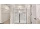 Bright bathroom features a glass enclosed shower with built in shelves and wood look floors at 313 Sound Cir # 140, Stockbridge, GA 30281